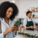 A woman smiling while looking down at her phone inside a store